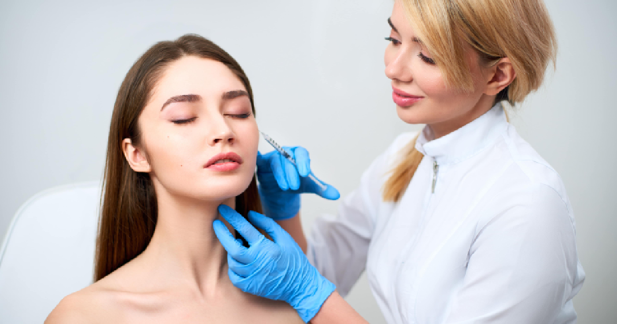 Practitioner performing facial volume treatment on calm woman in Fairfield, AU-a--